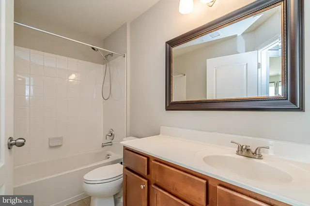 an empty room with a ceiling fan and window
