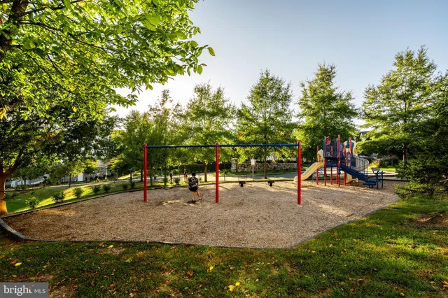 a sign board with buildings in the background