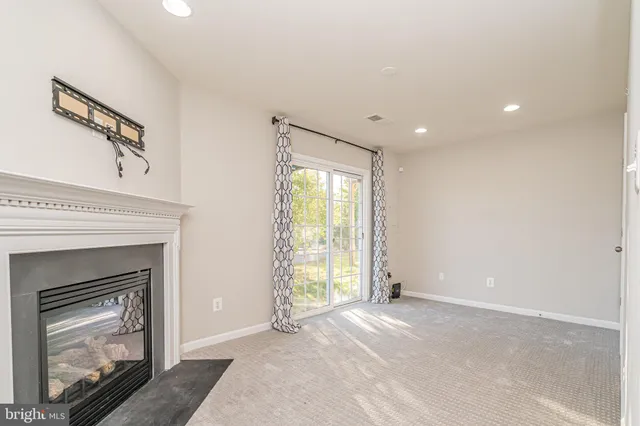 a view of empty room with fireplace