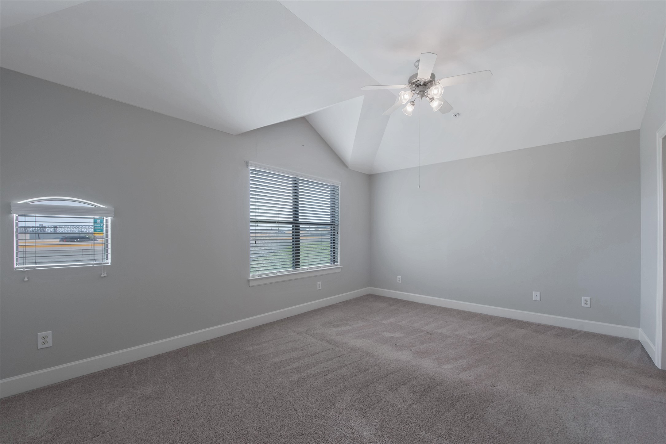 7650 Springhill Street, Unit 603 Houston, TX 77021 - Photo 13 of 26 an empty room with chandelier fan and windows