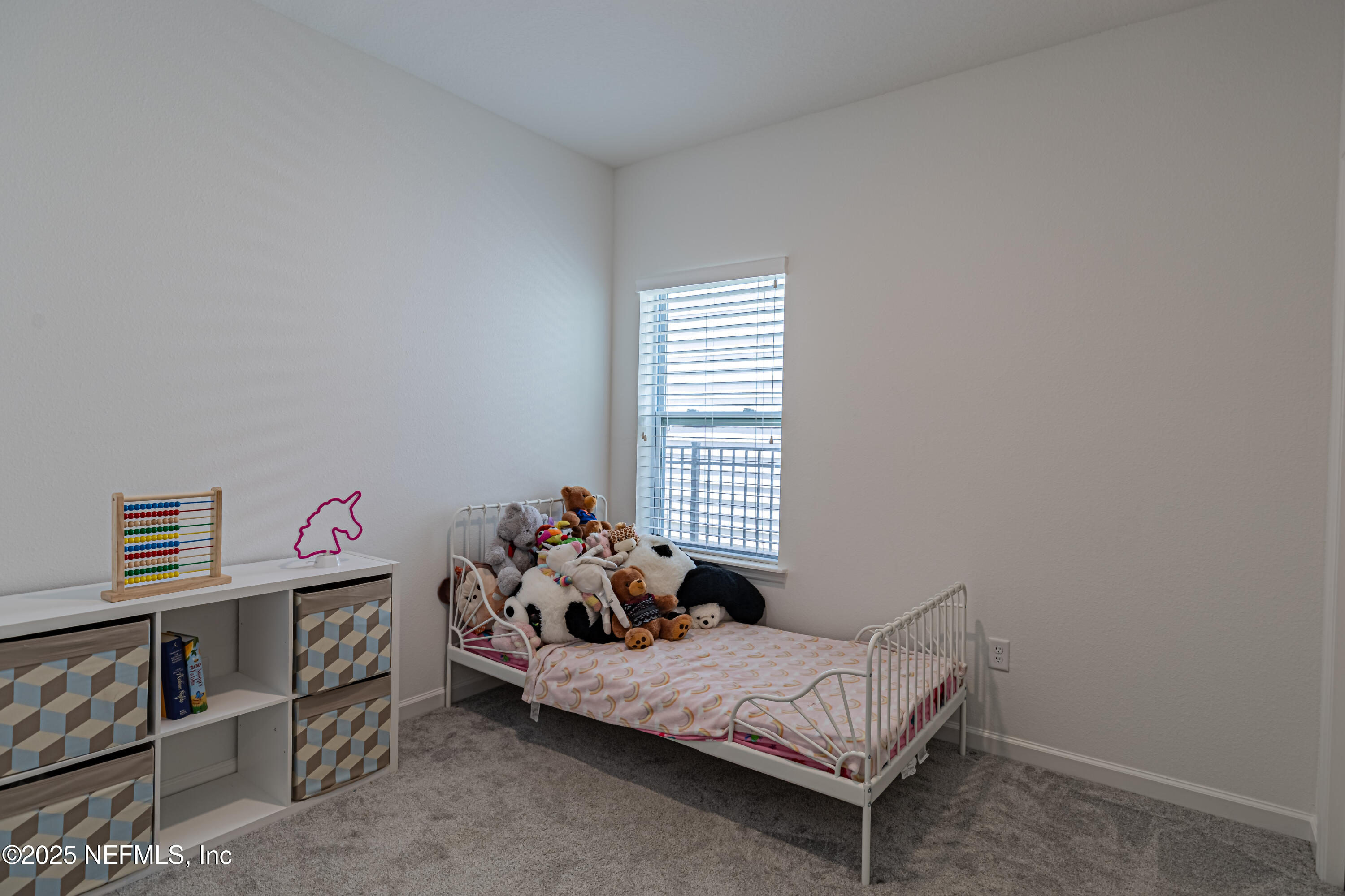 383 Windswept Way Street St. Augustine, FL 32092 - Photo 29 of 34 a bed room with a bed and a window