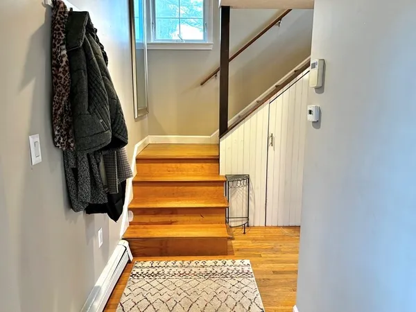 a front view of a house with a yard and trees