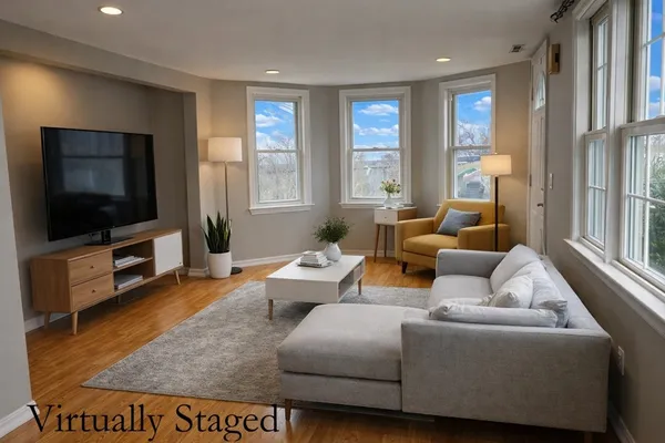 a living room with furniture and a flat screen tv