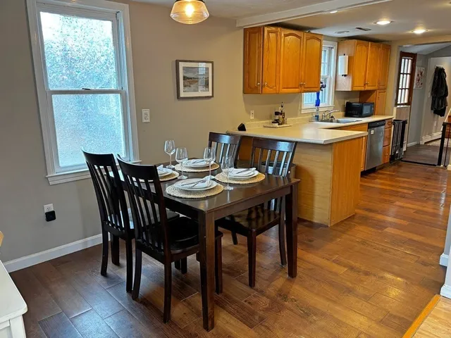a view of a dining room with furniture and window