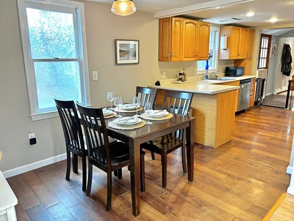 a view of a dining room with furniture and wooden floor