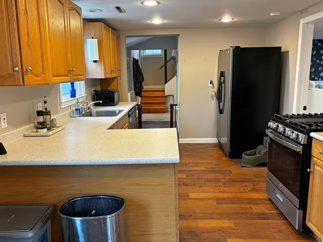 a kitchen with stainless steel appliances a stove a refrigerator and a sink