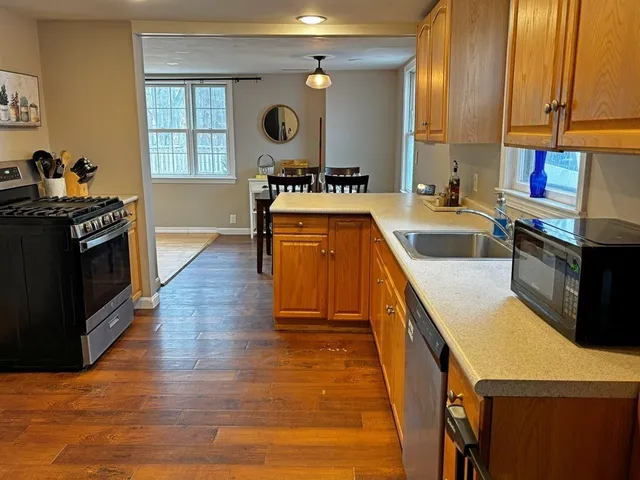 a kitchen with stainless steel appliances granite countertop a stove a sink and a refrigerator
