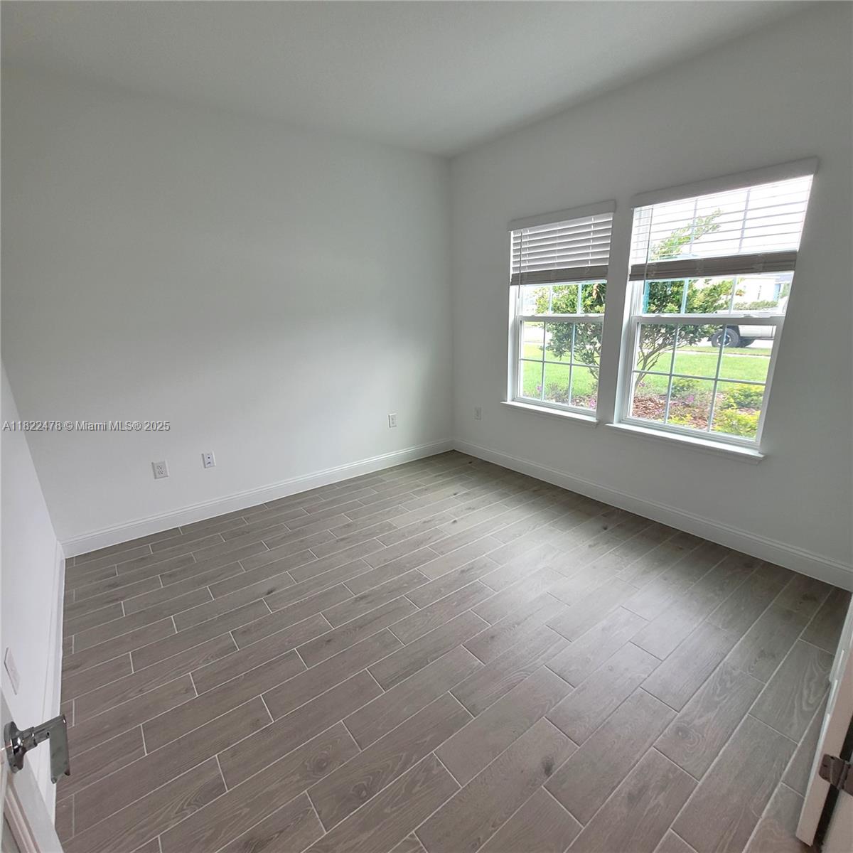 4155 Acoma Drive Ormond Beach, FL 32174 - Photo 16 of 49 an empty room with wooden floor and windows