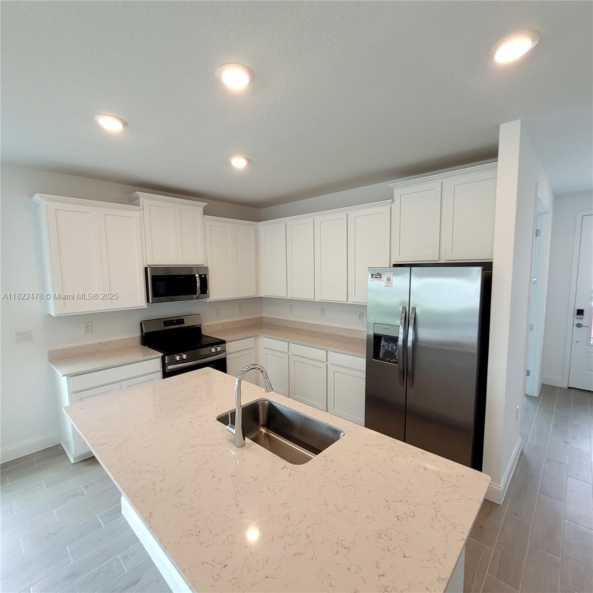 4155 Acoma Drive Ormond Beach, FL 32174 - Photo 21 of 49 a kitchen with stainless steel appliances a refrigerator sink and microwave