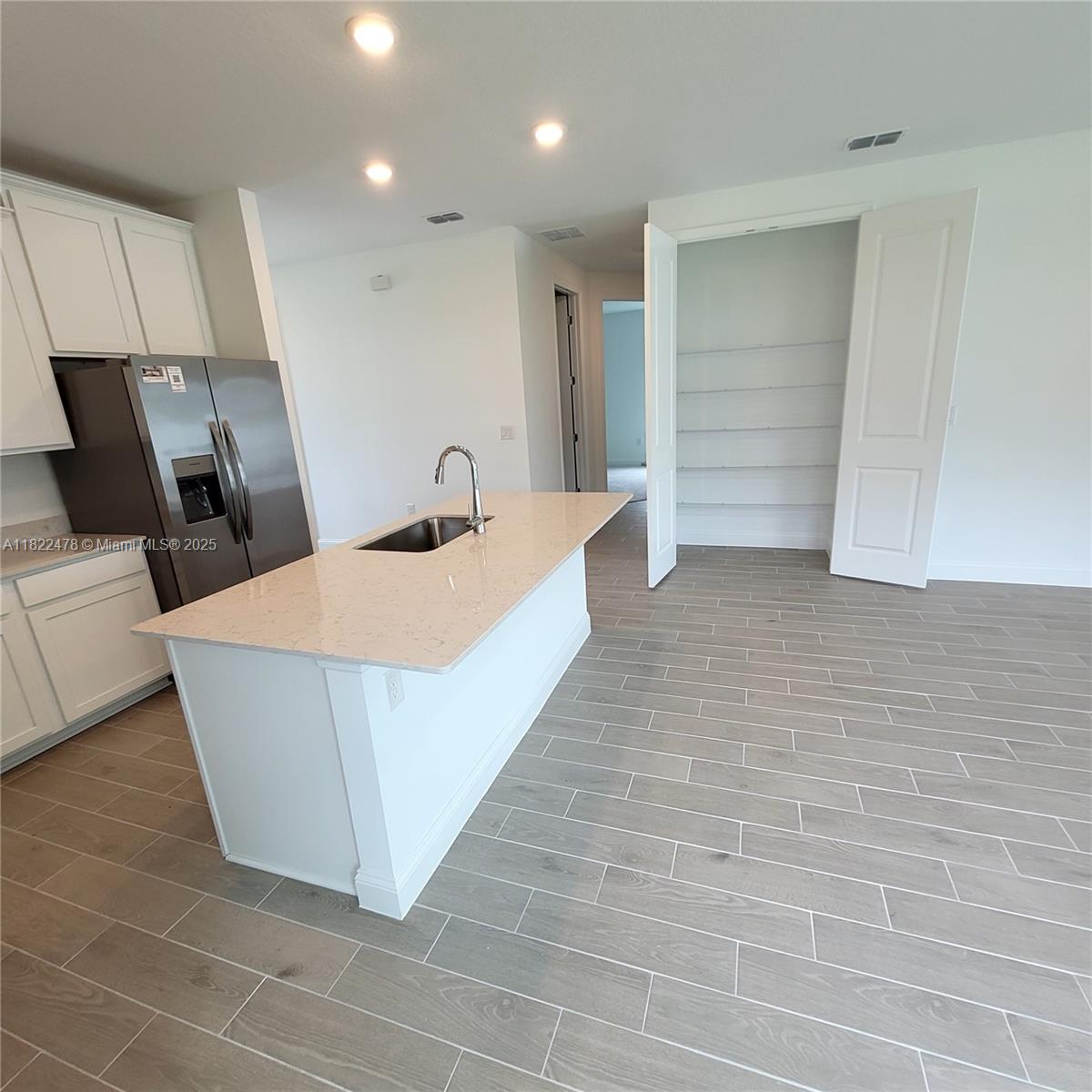 4155 Acoma Drive Ormond Beach, FL 32174 - Photo 29 of 49 a living room with stainless steel appliances furniture a sink and a refrigerator