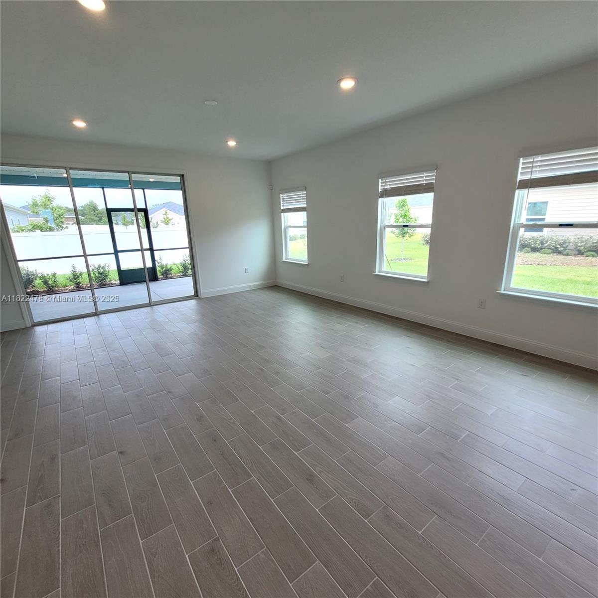 4155 Acoma Drive Ormond Beach, FL 32174 - Photo 30 of 49 an empty room with wooden floor and windows