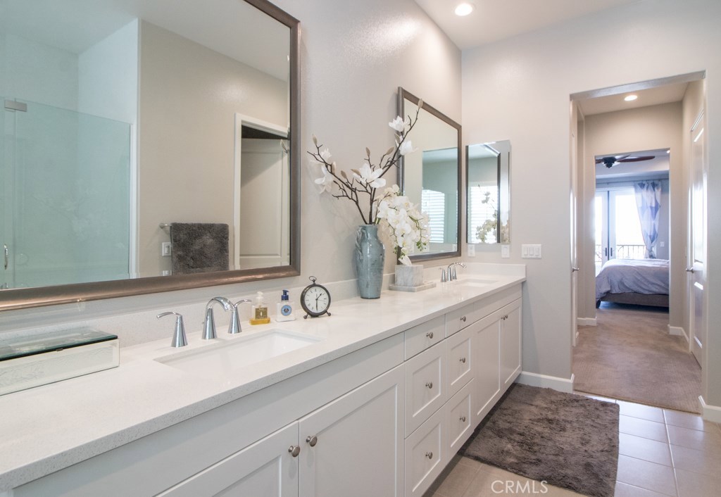 157 Follyhatch Irvine, CA 92618 - Photo 21 of 44 a en suite bathroom with double sink and a mirror