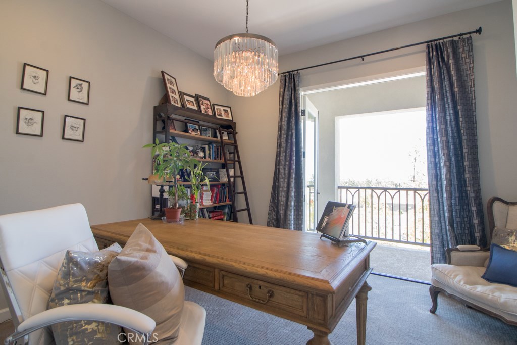 157 Follyhatch Irvine, CA 92618 - Photo 22 of 44 a living room with furniture a chandelier and a large window