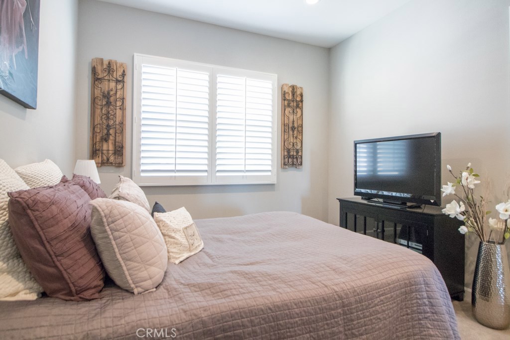 157 Follyhatch Irvine, CA 92618 - Photo 25 of 44 a bedroom with a bed and a flat screen tv