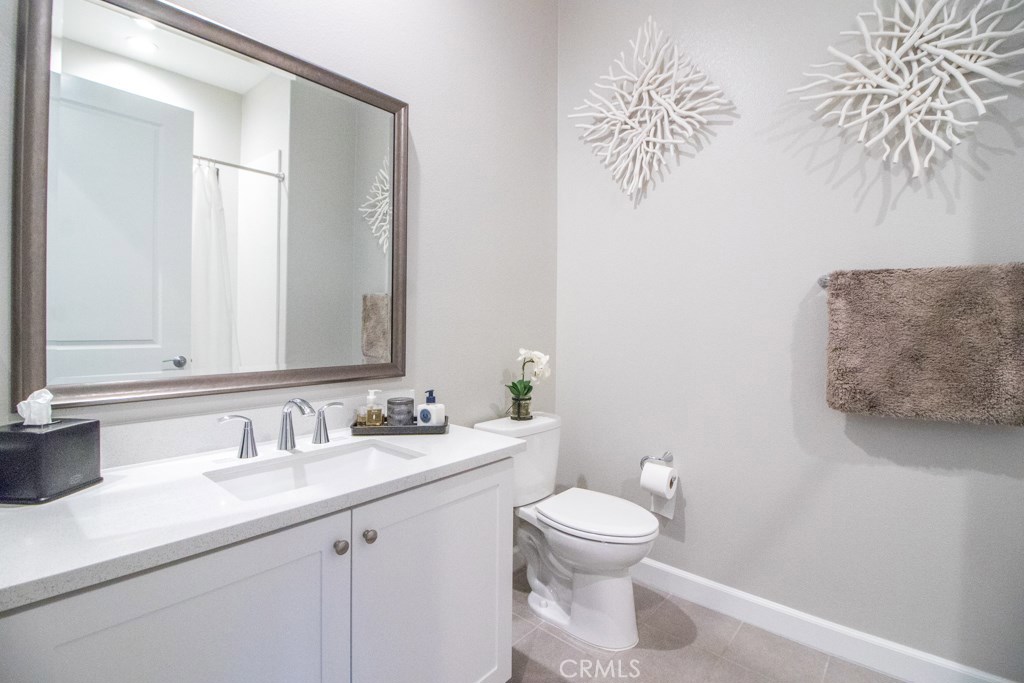 157 Follyhatch Irvine, CA 92618 - Photo 26 of 44 a bathroom with a toilet sink and mirror