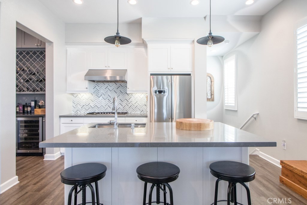 157 Follyhatch Irvine, CA 92618 - Photo 6 of 44 a kitchen with stainless steel appliances lots of counter space and wooden floor