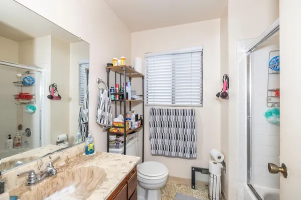a bathroom with a sink toilet and shower