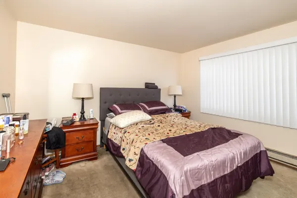 a bedroom with a bed and window
