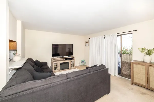 a living room with furniture and a mirror