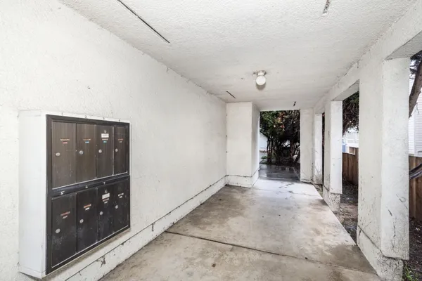 a view of a hallway with wooden shelves