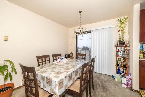 a view of a dining room with furniture and chandelier