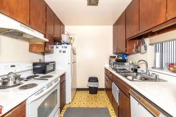 a kitchen with a sink stove and cabinets