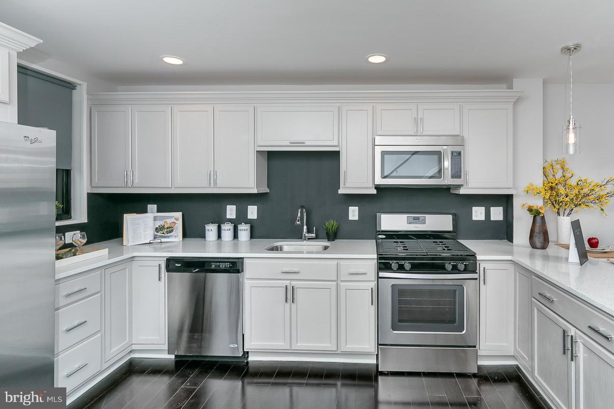 3 Cross Keys Road Baltimore, MD 21210 - Photo 2 of 29 a kitchen with white cabinets and appliances