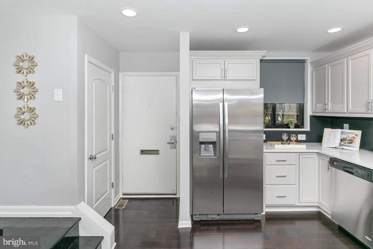 3 Cross Keys Road Baltimore, MD 21210 - Photo 11 of 29 a kitchen with a refrigerator and white cabinets