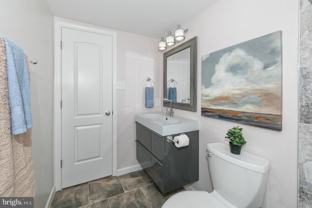3 Cross Keys Road Baltimore, MD 21210 - Photo 22 of 29 a bathroom with a toilet a sink and mirror