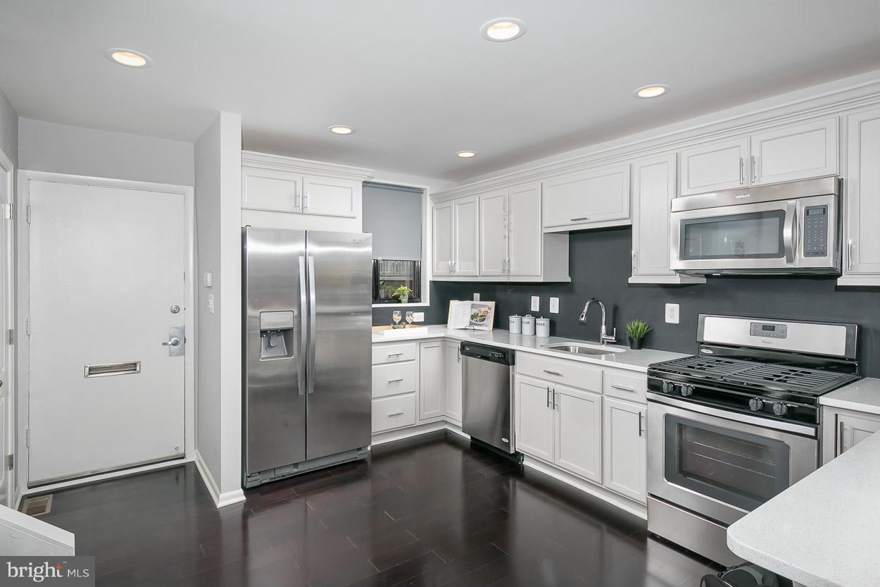 3 Cross Keys Road Baltimore, MD 21210 - Photo 7 of 29 a kitchen with stainless steel appliances granite countertop a refrigerator a stove a sink and a microwave