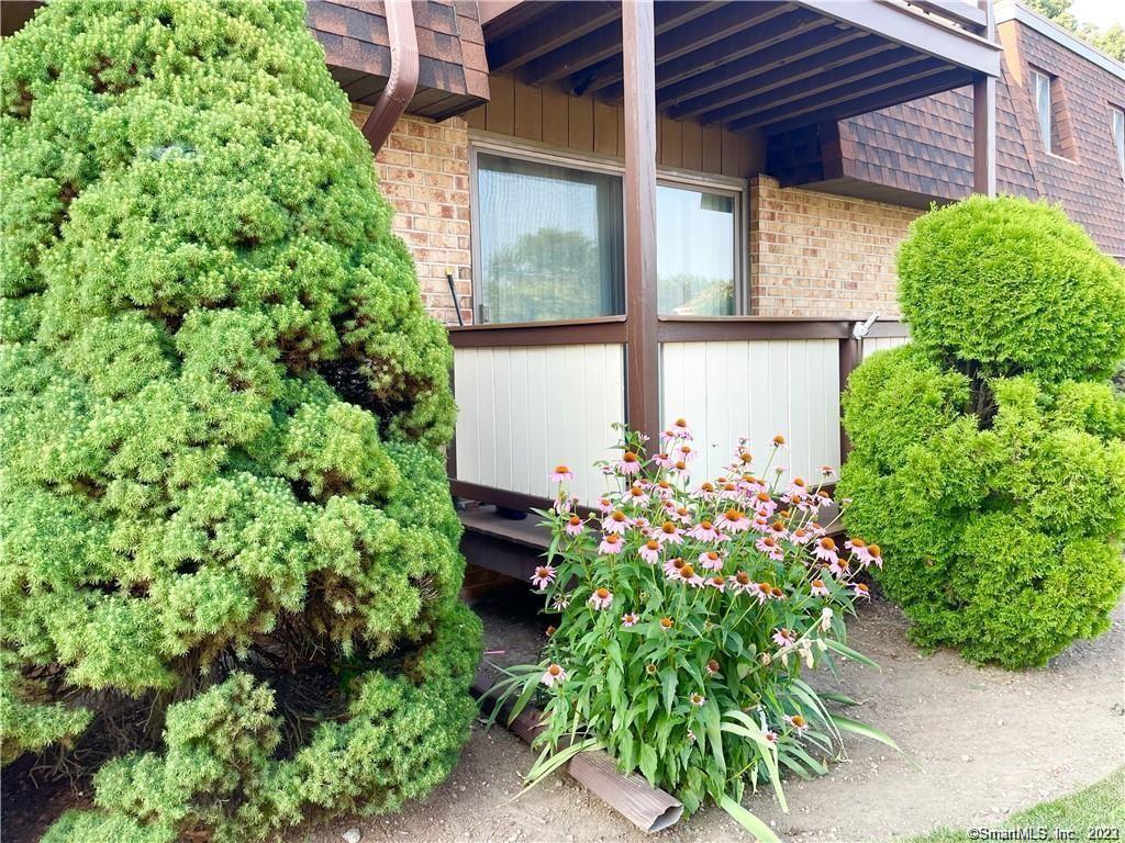front view of a house with a flower garden