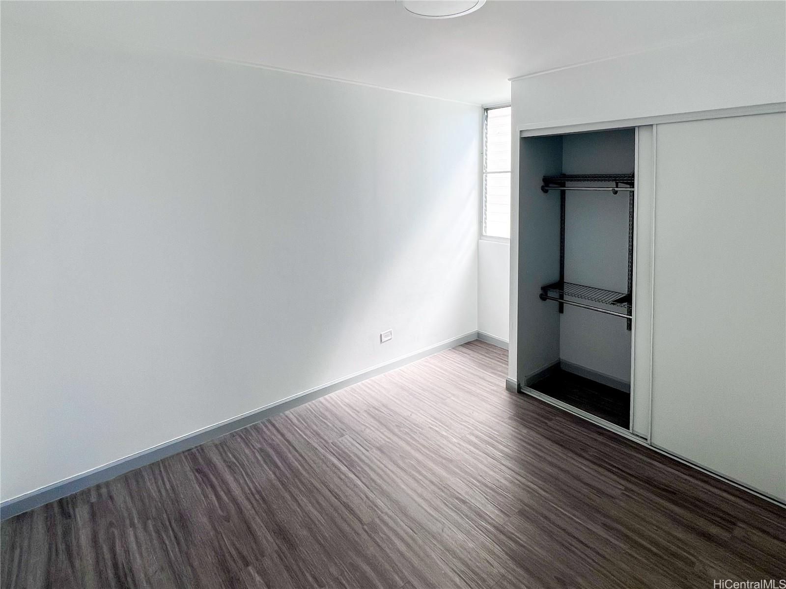 5210 Likini Street, Unit 901 Honolulu, HI 96818 - Photo 12 of 16 a view of an empty room with wooden floor and a window