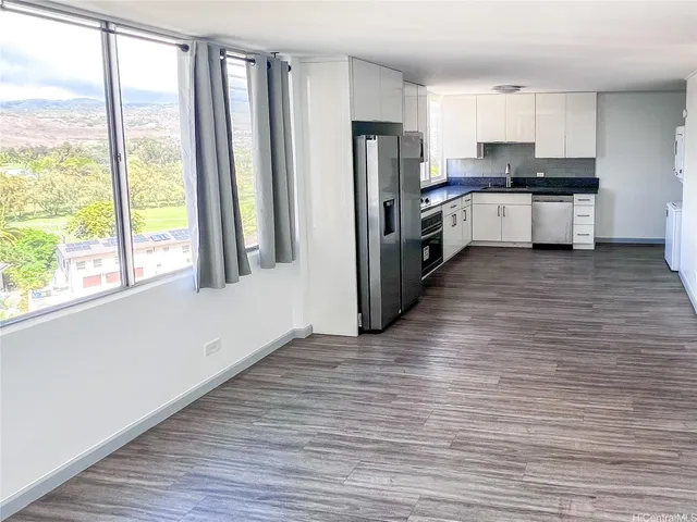a kitchen with stainless steel appliances a refrigerator sink and microwave