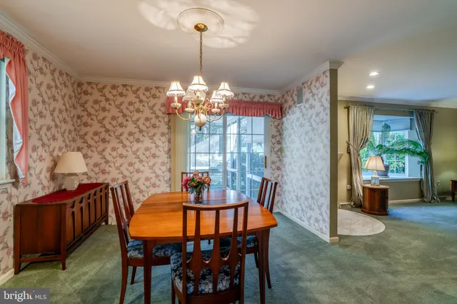a view of a dining room with furniture window and chandelier