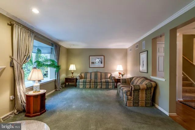 a living room with furniture a window and a flat screen tv