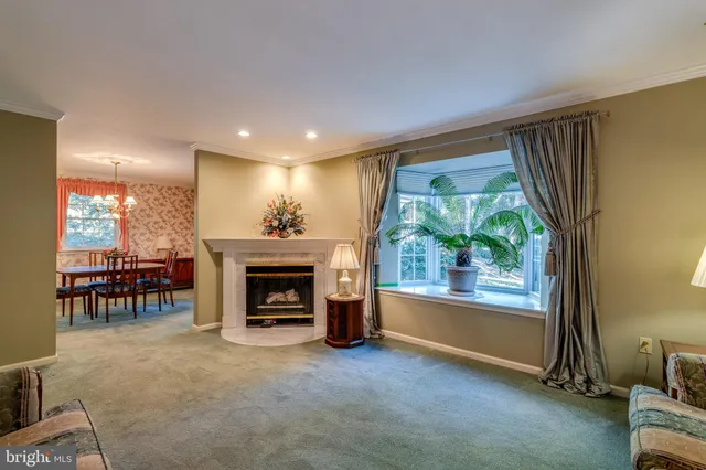 a view of a livingroom with a fireplace and window