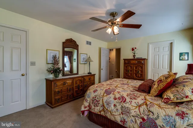 a bedroom with a large bed and a chandelier