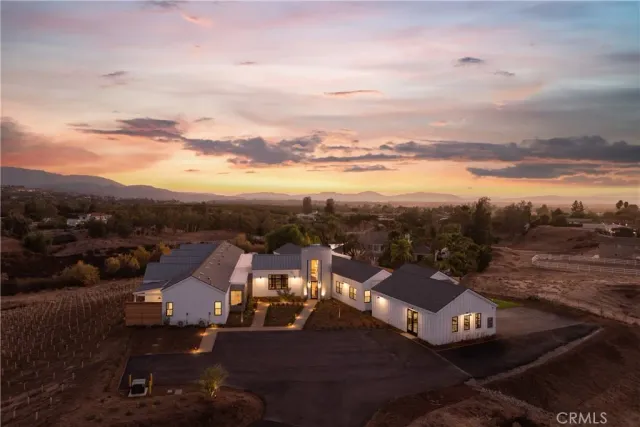 an aerial view of a city with lots of residential buildings ocean and mountain view in back