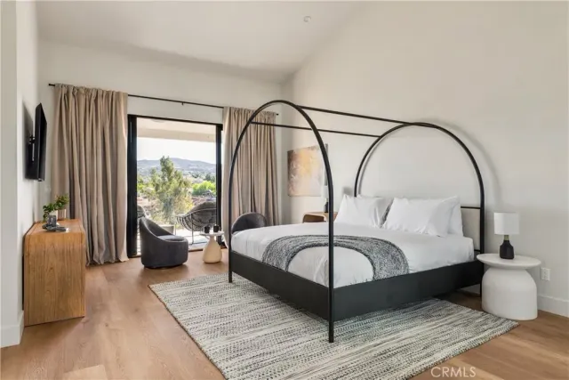 a bedroom with bed and a large window