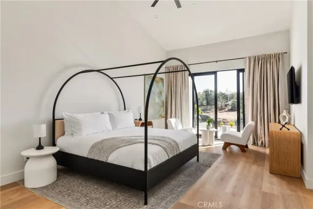 a bedroom with a bed and a large window