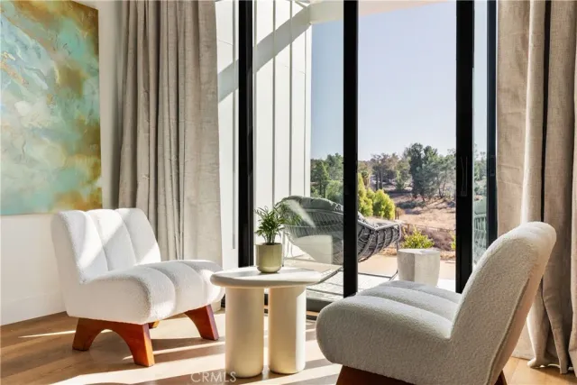 a living room with furniture and a floor to ceiling window