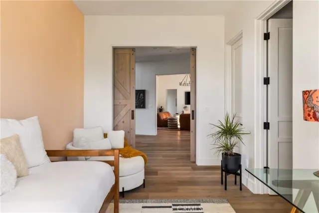 a living room with furniture and wooden floor