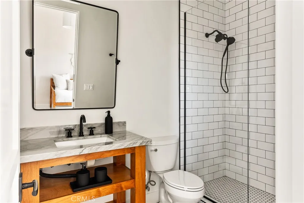 39241 Corte Venture Temecula, CA 92590 - Photo 37 of 49 a bathroom with a granite countertop toilet sink and shower