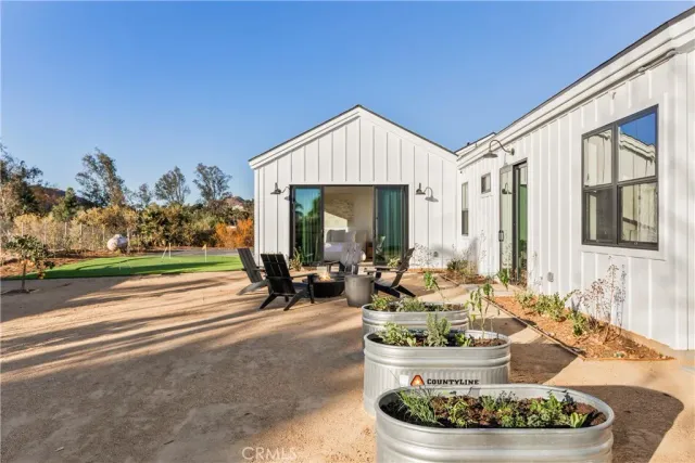 a view of a house with backyard and patio