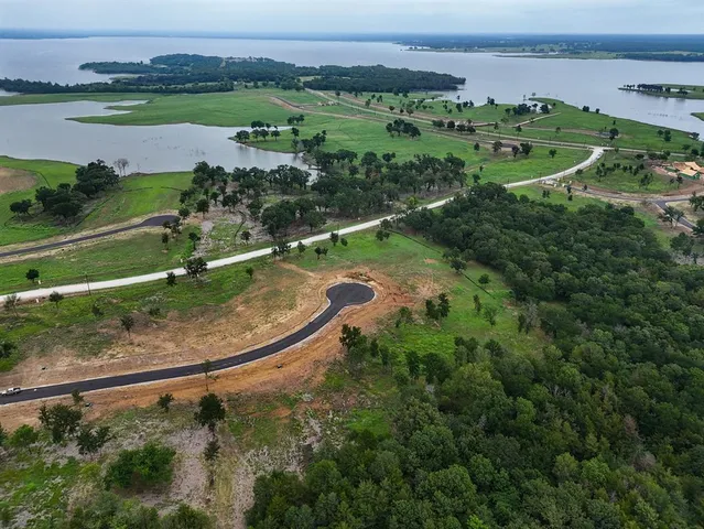 an aerial view of a houses with outdoor space and river
