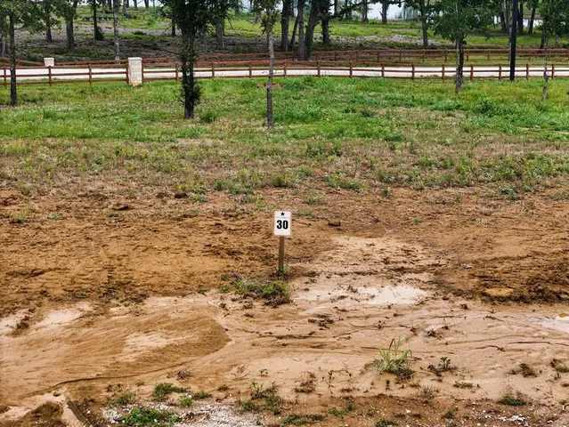 a backyard of a house with lots of green space and trees