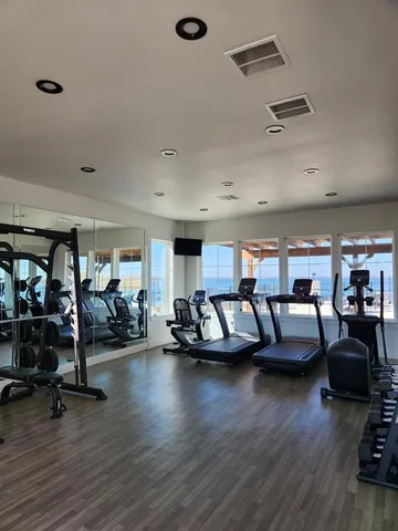 a living room with furniture and hard wood flooring