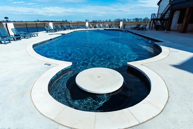 a view of a swimming pool with an outdoor seating
