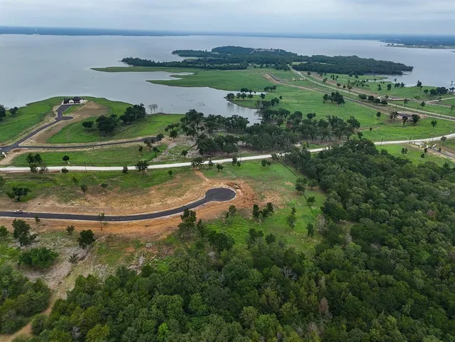 an aerial view of a houses with outdoor space and river