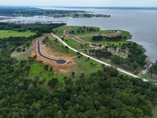 an aerial view of a golf course with a swimming pool